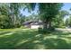 Well-maintained home exterior with lush green lawn and mature trees offering ample shade at 264 Agnes Ave, Longwood, FL 32750