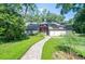 Charming home featuring a paved walkway leading to the entrance, set amidst a lush, landscaped yard at 264 Agnes Ave, Longwood, FL 32750
