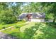 Charming home featuring a well-manicured lawn, mature trees, and a brick pathway leading to the front door at 264 Agnes Ave, Longwood, FL 32750