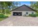 Two car garage with two parked vehicles, ample storage, and a paver driveway at 264 Agnes Ave, Longwood, FL 32750
