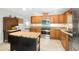 Well-equipped kitchen with wooden cabinets, granite countertops, stainless steel appliances, and tile flooring at 264 Agnes Ave, Longwood, FL 32750