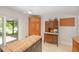 Kitchen featuring custom cabinetry, an island with butcher block top, and an antique cabinet at 264 Agnes Ave, Longwood, FL 32750