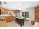Open kitchen with granite countertops, stainless steel appliances, a central island, and a sliding glass door to the patio at 264 Agnes Ave, Longwood, FL 32750