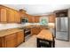 Well-equipped kitchen with stainless steel appliances, wooden cabinets, and a butcher block island at 264 Agnes Ave, Longwood, FL 32750