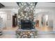 Interior view of a stone fireplace with hearth and decorative mantel, with doorways to adjoining rooms at 264 Agnes Ave, Longwood, FL 32750