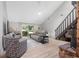 Bright living room with vaulted ceiling, light wood floors, comfortable seating, and a sliding glass door to the patio at 264 Agnes Ave, Longwood, FL 32750