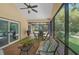 Relaxing screened patio with comfortable seating and a ceiling fan, perfect for outdoor dining and entertaining at 264 Agnes Ave, Longwood, FL 32750