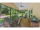 A spacious screened patio featuring an outdoor dining area, comfortable seating, and a grill at 264 Agnes Ave, Longwood, FL 32750
