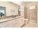 Bright bathroom features double sinks, a large mirror, and a modern glass-enclosed shower at 2665 Petition Ln, Kissimmee, FL 34746