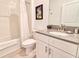 Clean bathroom showcases a vanity with a gray countertop, a framed mirror, and a shower-tub combo at 2665 Petition Ln, Kissimmee, FL 34746