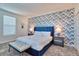 Stylish bedroom with a bold accent wall, plush carpeting, and modern furnishings at 2665 Petition Ln, Kissimmee, FL 34746