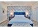 Stylish bedroom featuring an accent wall, plush carpeting, and modern furnishings at 2665 Petition Ln, Kissimmee, FL 34746