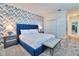 Charming bedroom featuring an accent wall, plush carpeting, and modern furnishings at 2665 Petition Ln, Kissimmee, FL 34746