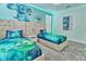 Charming bedroom with two beds, carpet, and walls featuring characters from Monsters, Inc at 2665 Petition Ln, Kissimmee, FL 34746