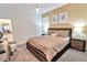 Inviting bedroom features a king bed, soft lighting, and neutral tones for a serene and restful atmosphere at 2665 Petition Ln, Kissimmee, FL 34746