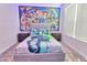 A bedroom with a large Toy Story mural, neutral colors, and carpet at 2665 Petition Ln, Kissimmee, FL 34746