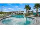 Large community pool surrounded by ample lounge seating and lush tropical landscaping, offering a resort-like atmosphere at 2665 Petition Ln, Kissimmee, FL 34746