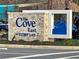 Stone sign for 'The Cove East at Storey Lake' community, surrounded by lush greenery at 2665 Petition Ln, Kissimmee, FL 34746