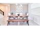 Modern dining area features wood table, bench seating, contemporary lighting, and tasteful decor at 2665 Petition Ln, Kissimmee, FL 34746