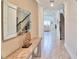 Inviting entryway with sleek console table, decorative mirror, leading to an open-concept living space at 2665 Petition Ln, Kissimmee, FL 34746