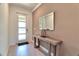 Bright entryway featuring a modern door, stylish mirror and contemporary console table at 2665 Petition Ln, Kissimmee, FL 34746