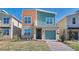 Charming two-story home with colorful exterior, one car garage and neatly landscaped front yard at 2665 Petition Ln, Kissimmee, FL 34746