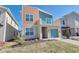 Modern two-story home with colorful siding, one car garage and a beautifully landscaped front yard at 2665 Petition Ln, Kissimmee, FL 34746
