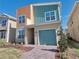 Stylish two-story home with vibrant siding, one-car garage and meticulously landscaped front yard at 2665 Petition Ln, Kissimmee, FL 34746