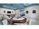 Inviting game room with a poker table, pool table, dart boards, and comfortable seating, accented by stone walls at 2665 Petition Ln, Kissimmee, FL 34746