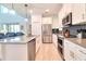 Modern kitchen with stainless steel appliances, an island with barstool seating, and a tile backsplash at 2665 Petition Ln, Kissimmee, FL 34746
