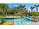 Picturesque lazy river with playful water features, surrounded by tropical landscaping, bridges, and comfortable seating at 2665 Petition Ln, Kissimmee, FL 34746