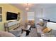 Cozy living room features comfortable seating, stylish decor, and a modern media console at 2665 Petition Ln, Kissimmee, FL 34746