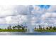 Scenic view of a tall water fountain in the community pond, set against a backdrop of fluffy clouds and landscaping at 2665 Petition Ln, Kissimmee, FL 34746