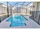 An enclosed outdoor pool and spa area at 2665 Petition Ln, Kissimmee, FL 34746