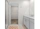 Bright bathroom featuring dual vanities, tile flooring, and a glass enclosed shower at 2817 Muller Oak Loop, Ocoee, FL 34761