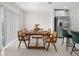 Charming dining area with natural wood table and chairs, adjacent to the modern kitchen at 2817 Muller Oak Loop, Ocoee, FL 34761