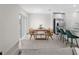 Bright dining area with modern table and chairs, seamlessly connecting to the kitchen and living space at 2817 Muller Oak Loop, Ocoee, FL 34761
