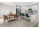 Bright kitchen with stainless steel appliances, island seating, and adjacent dining area is great for entertaining at 2817 Muller Oak Loop, Ocoee, FL 34761