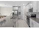 Modern kitchen with stainless steel appliances, gray counters, and an island with a sink at 2817 Muller Oak Loop, Ocoee, FL 34761