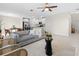 Open-concept living room with modern furnishings, a dining area, and a view into the kitchen at 2817 Muller Oak Loop, Ocoee, FL 34761