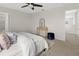 Main bedroom featuring neutral decor, soft carpet, and a stylish upholstered bed at 2817 Muller Oak Loop, Ocoee, FL 34761