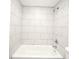 Tiled bathtub and shower combination featuring white marble tile at 3057 Aaron Burr Ave # 1, Winter Park, FL 32792