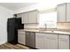 Kitchen showcasing granite countertops, stainless steel appliances, and gray cabinetry at 3057 Aaron Burr Ave # 1, Winter Park, FL 32792