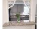 View of the gray kitchen cabinets and countertops through an ornate passthrough feature at 3057 Aaron Burr Ave # 1, Winter Park, FL 32792