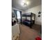 A room is equipped with a sturdy bunk bed, perfect for sleepovers and maximizing space, creating a cozy retreat at 306 Captiva Dr, Davenport, FL 33896