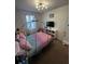 This bedroom features a canopy bed, creating a magical and enchanting atmosphere, perfect for imaginative play at 306 Captiva Dr, Davenport, FL 33896