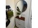 Stylish entryway with decorative mirror, shoe cabinet, and convenient storage hooks at 306 Captiva Dr, Davenport, FL 33896