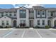 Charming two-story townhome features neutral paint, tile roof, and well-maintained landscaping at 306 Captiva Dr, Davenport, FL 33896