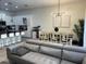 Open-concept living and dining area with modern furnishings and bright lighting at 306 Captiva Dr, Davenport, FL 33896