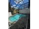 Relaxing in-ground pool surrounded by a screened enclosure perfect for outdoor enjoyment at 306 Captiva Dr, Davenport, FL 33896